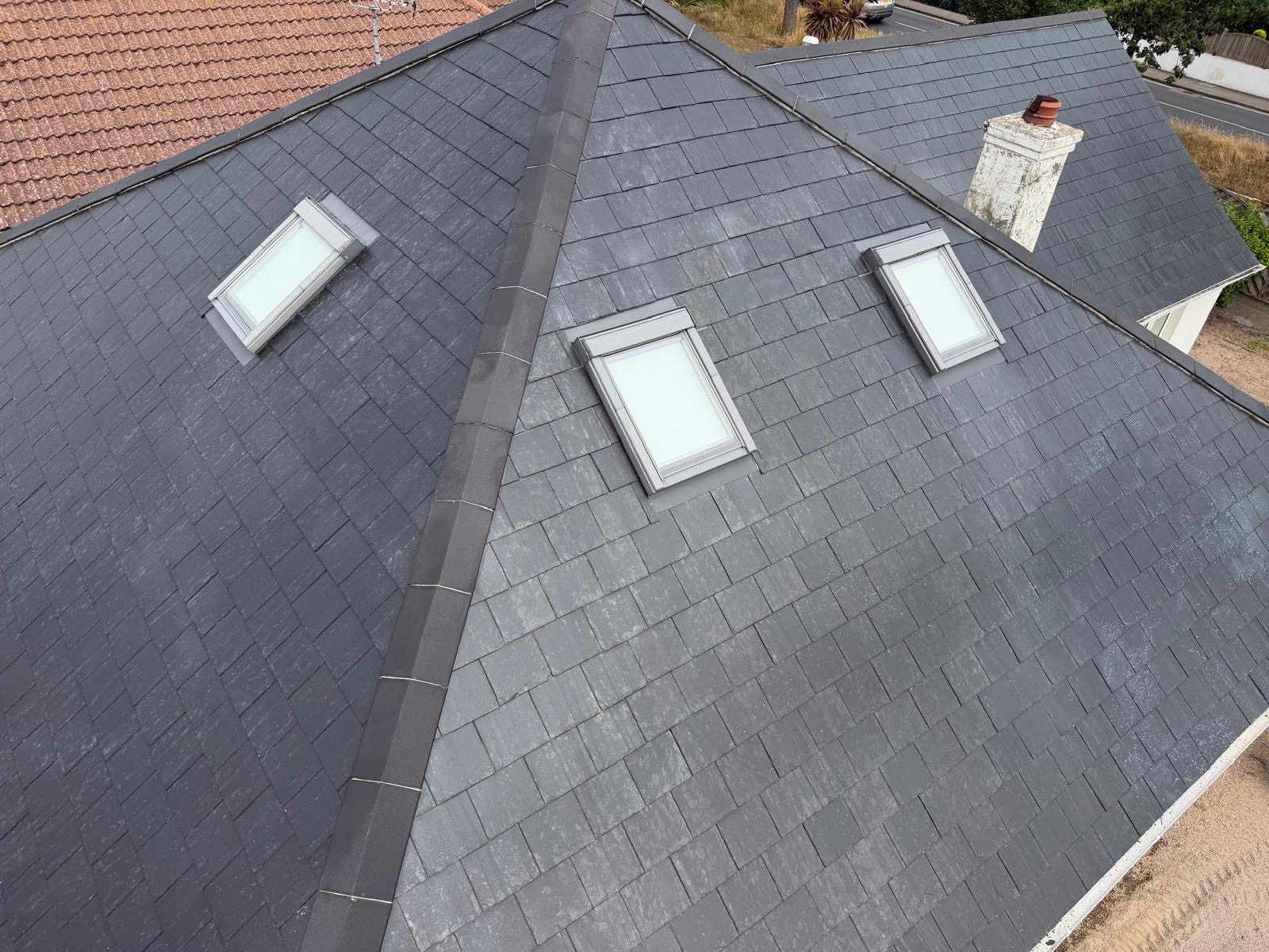 Aerial view of cleaned grey roof planes and rooflights after roof cleaning.