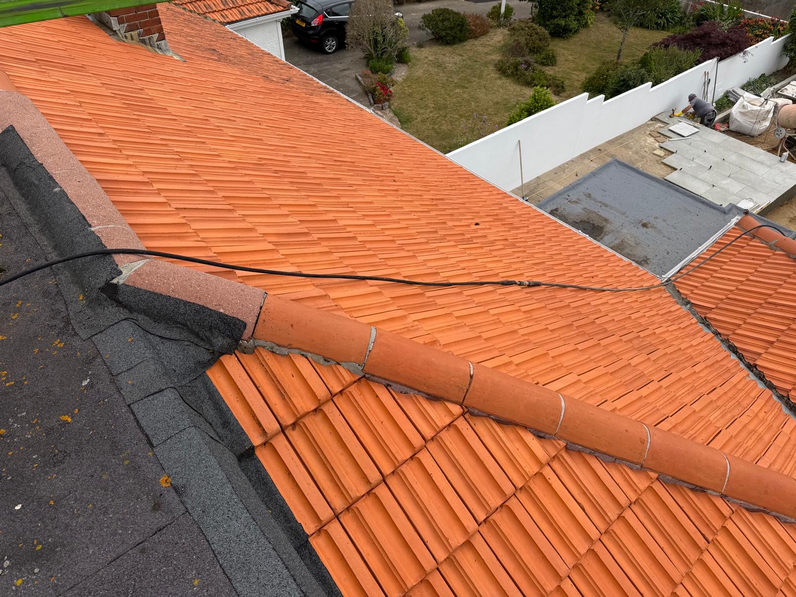 Orange concrete roof tiles in original condition before restoration treatment.