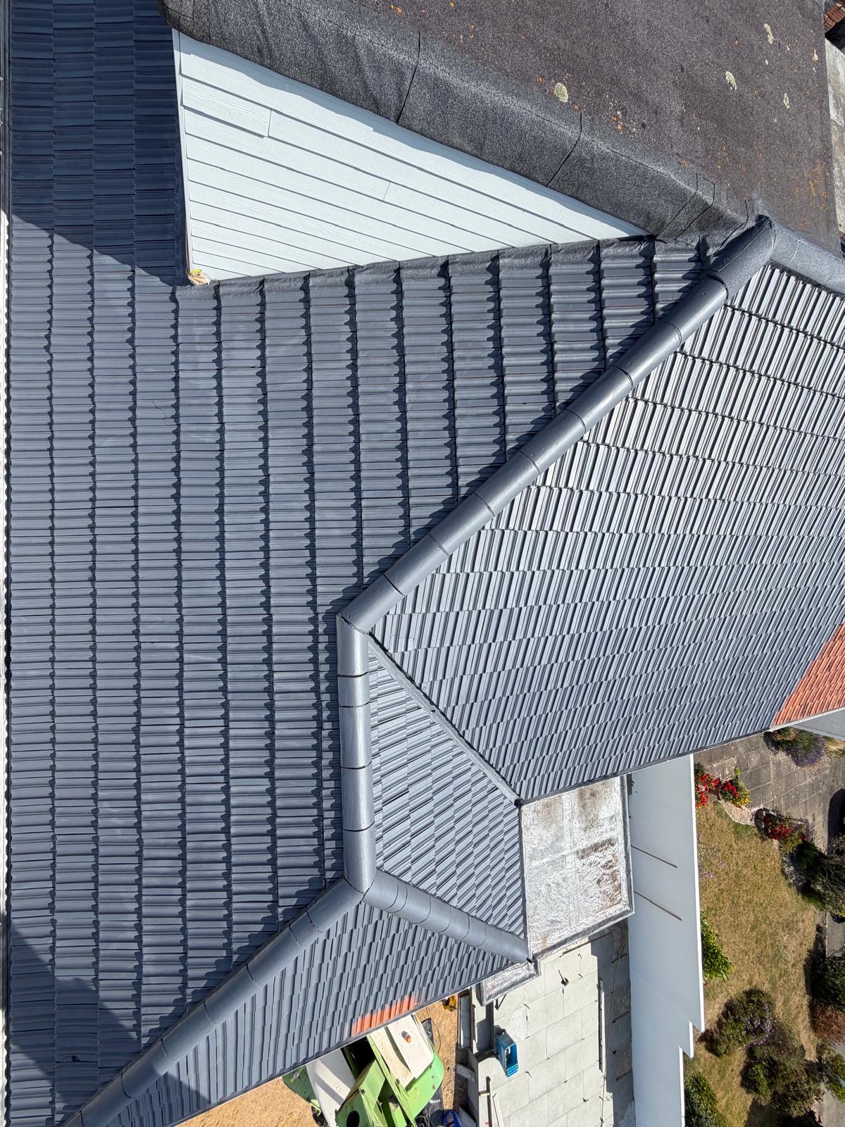 Overhead view of a completed roof restoration with uniform grey coverage.