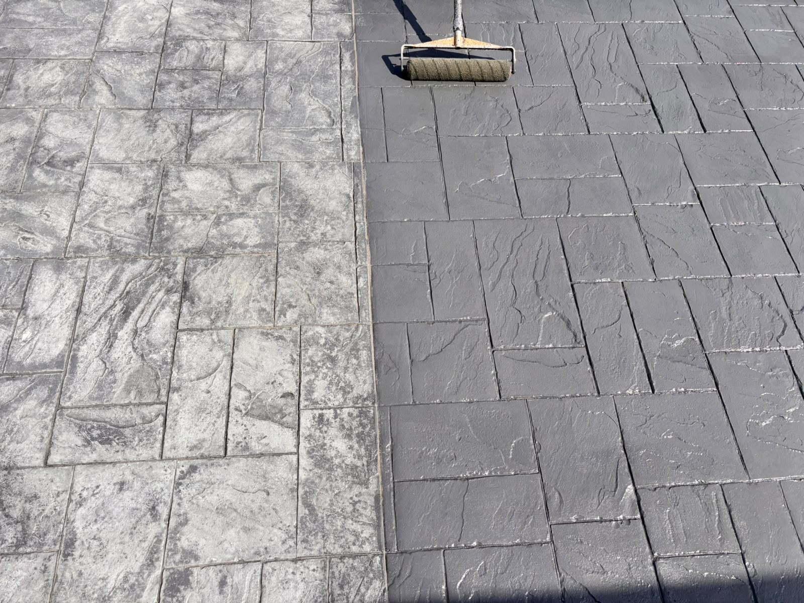 Driveway restoration treatment being applied to imprinted concrete.