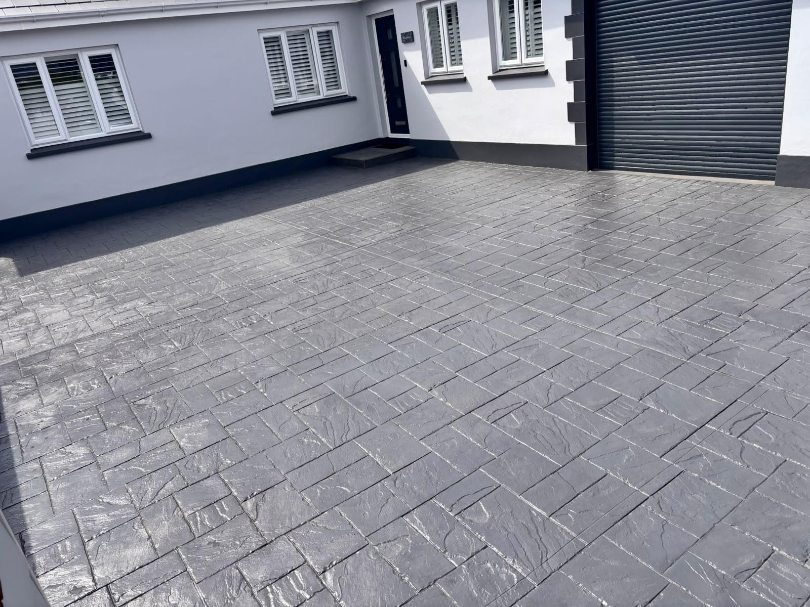 Completed imprinted concrete driveway after restoration.