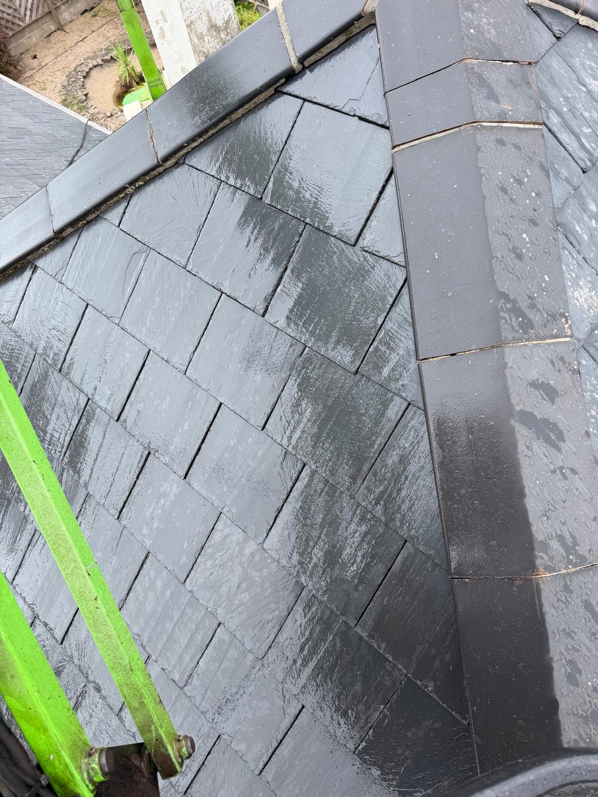 Grey roof during cleaning with work in progress across the roof surface.