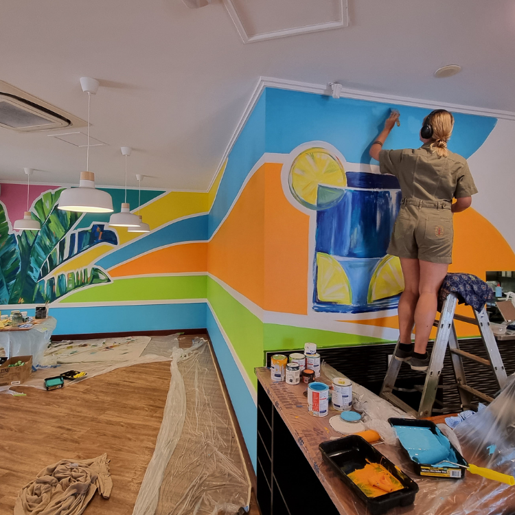 Painting a colourful indoor mural