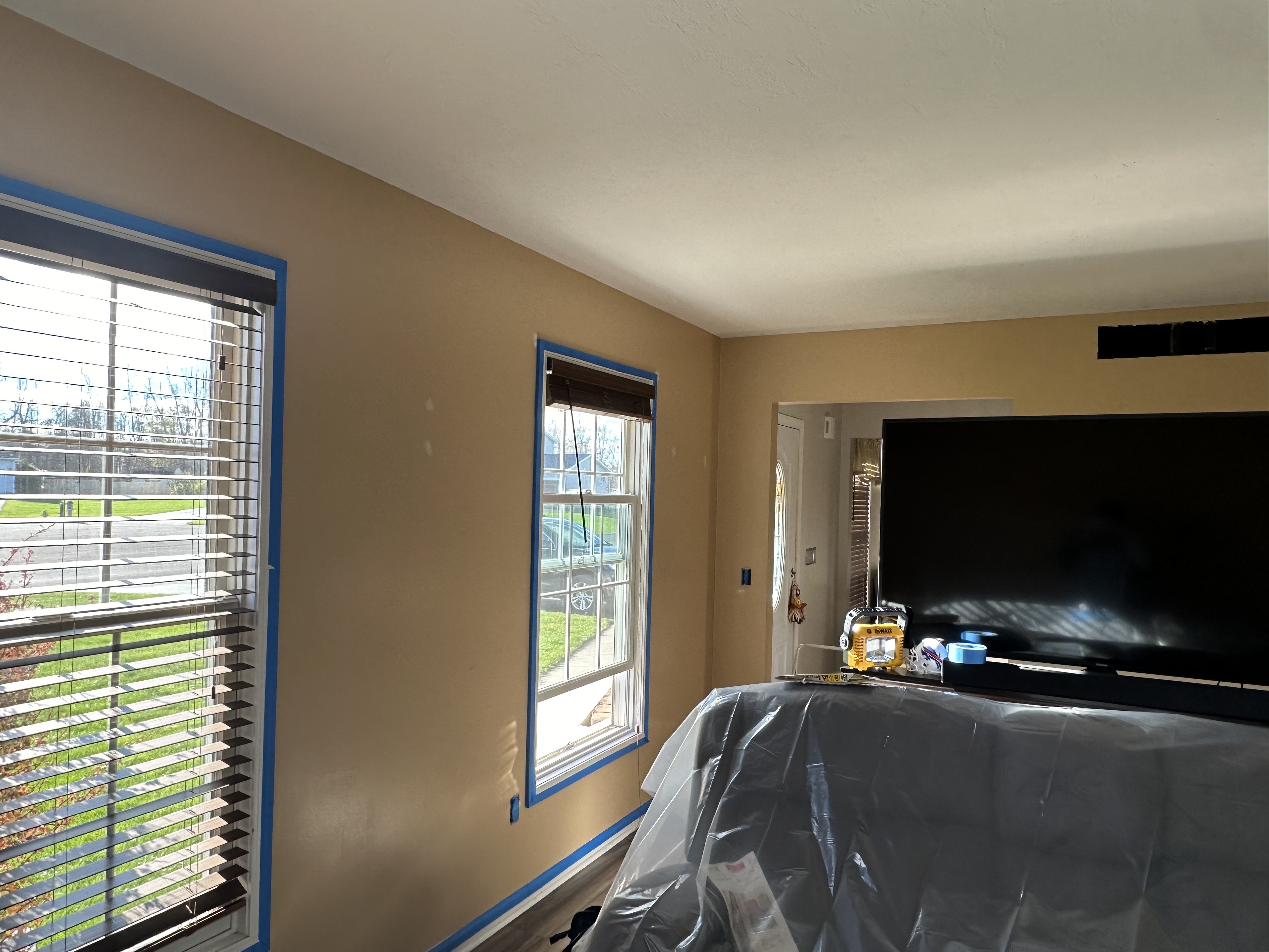 Windows taped off with blue painter's tape before painting