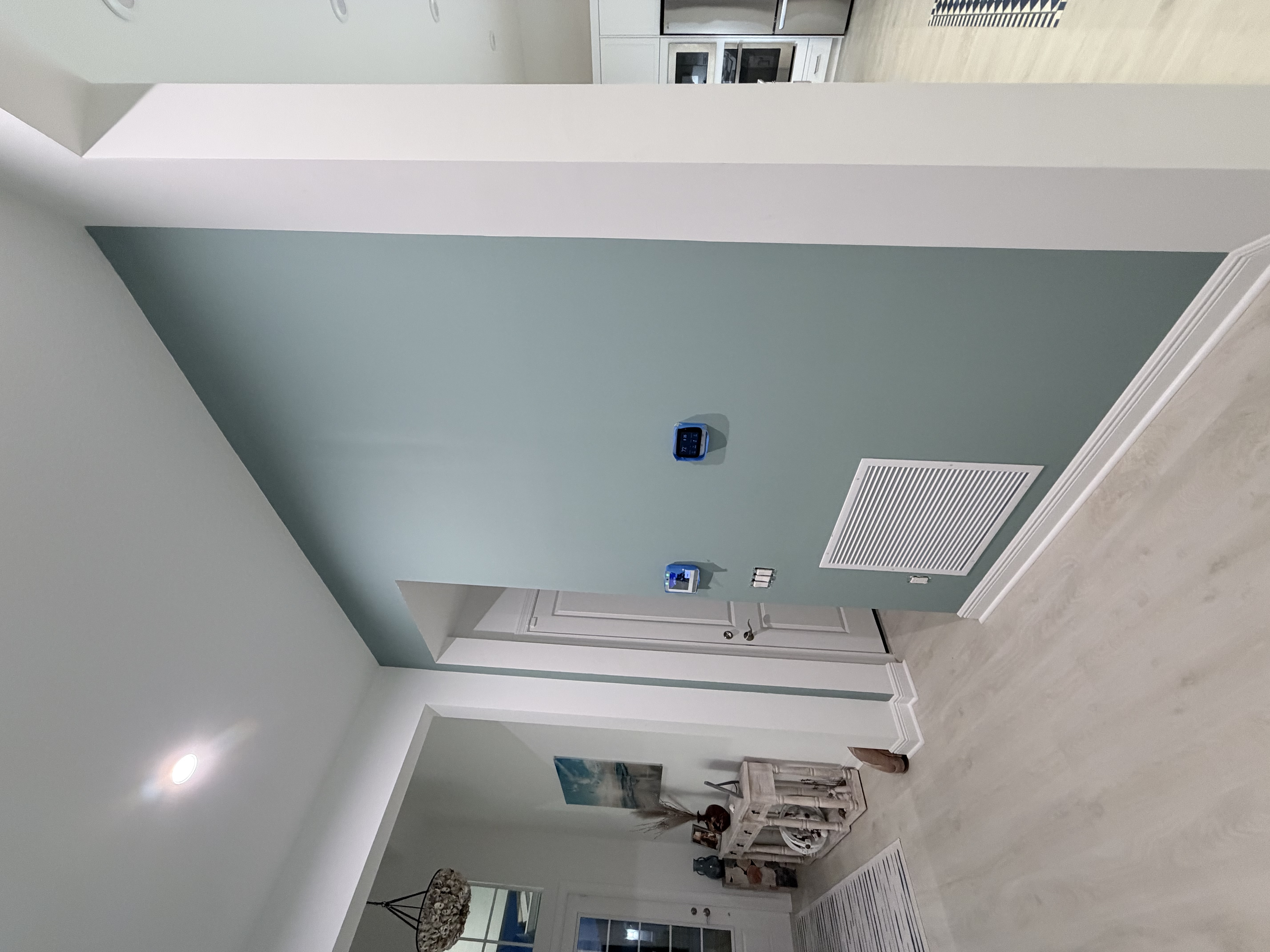 Soft sage green accent wall in an entry hallway