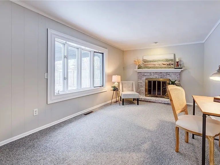 Living room with fresh walls and a brick fireplace