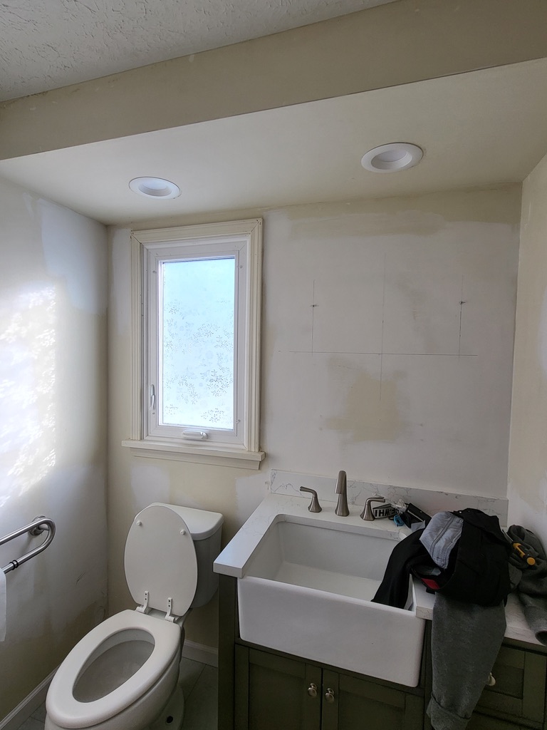 Bathroom before painting with patched walls