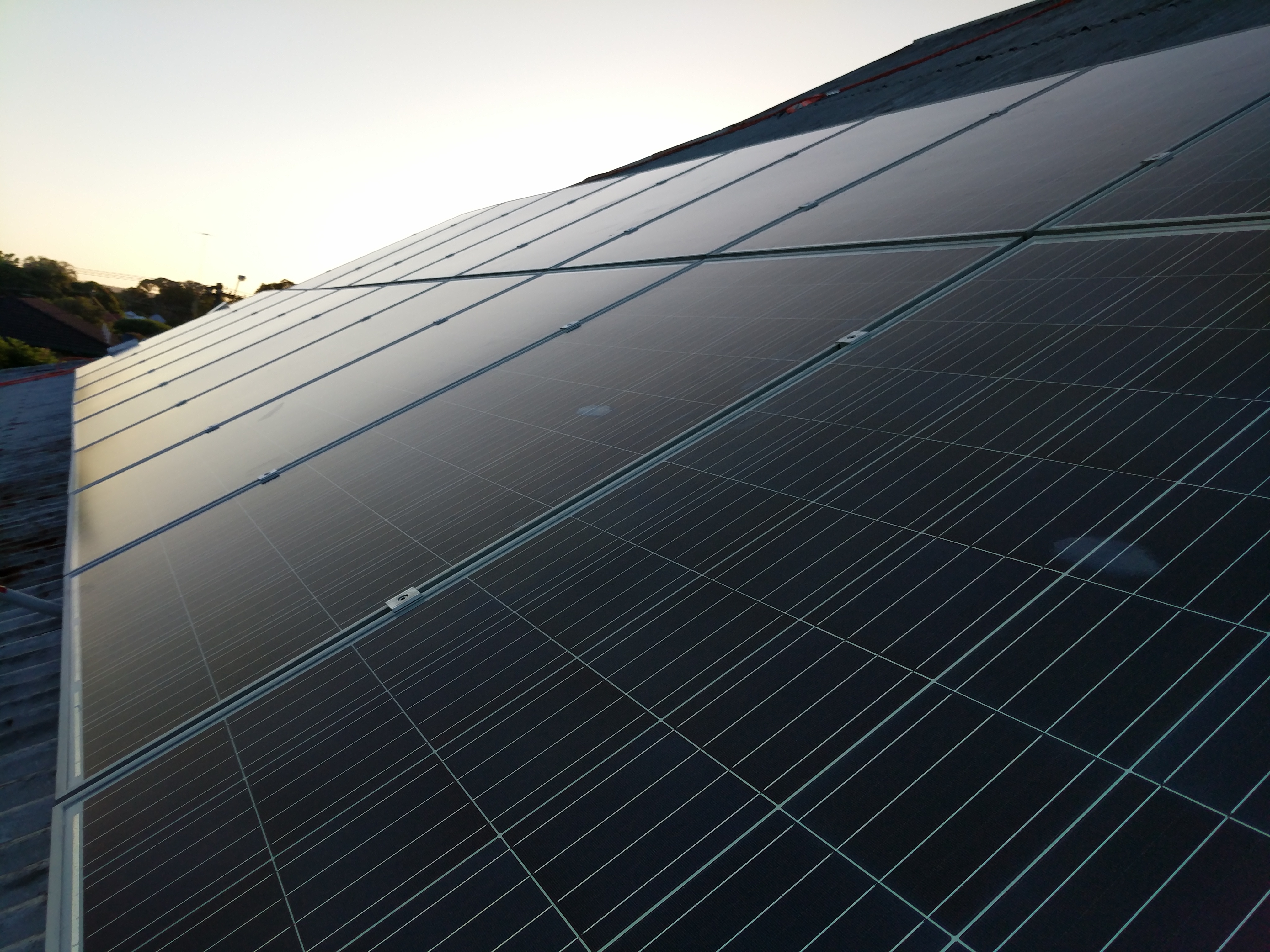 Angled view of a residential photovoltaic panel array.