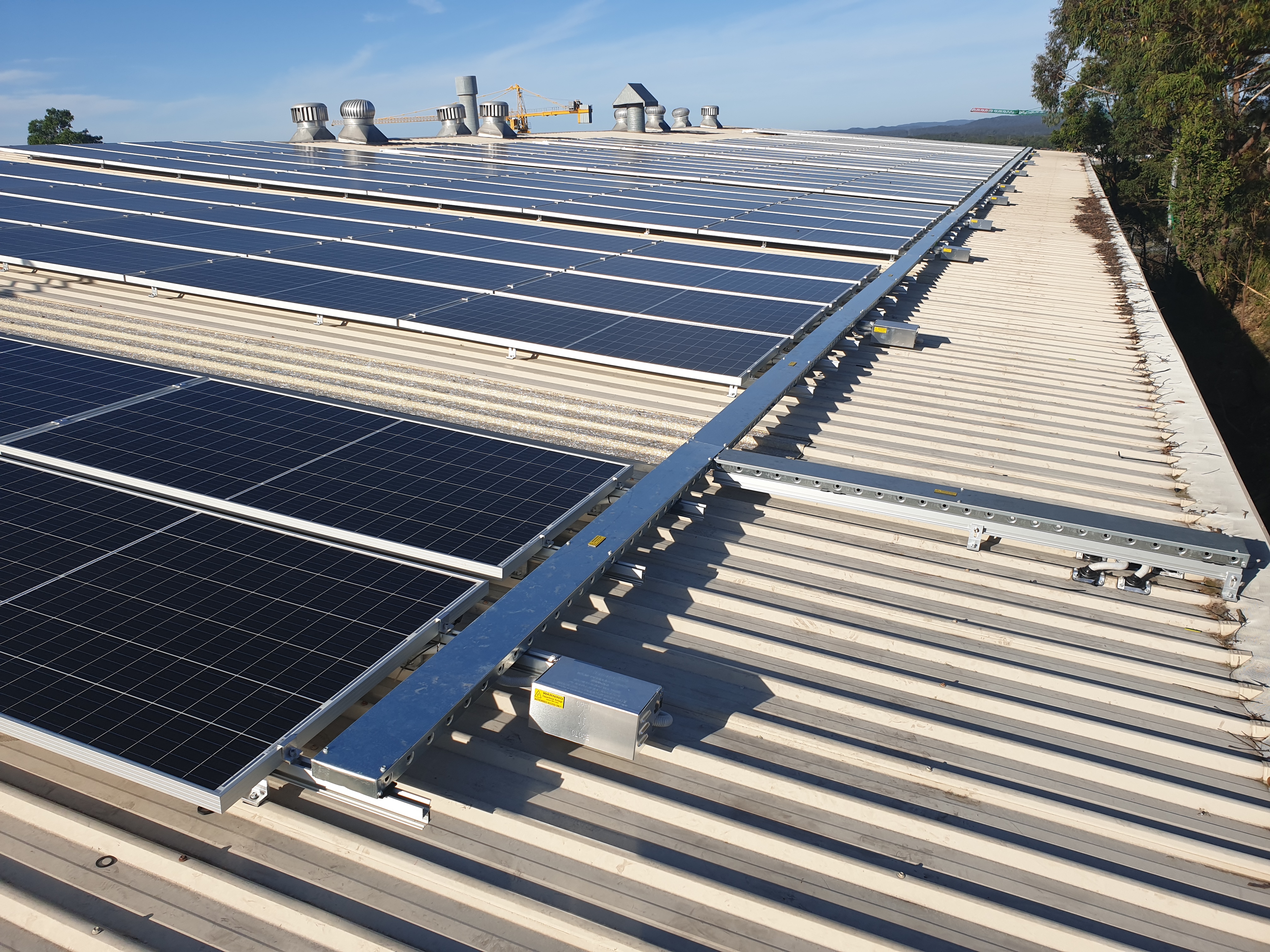 Large rooftop photovoltaic array showing scale and array layout.