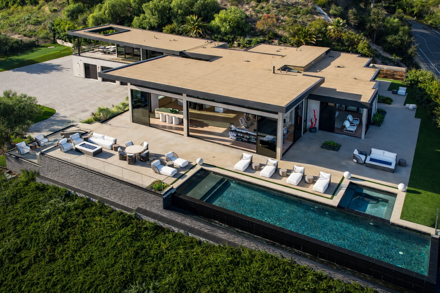 Modern Malibu hillside home backyard with pool and outdoor living space