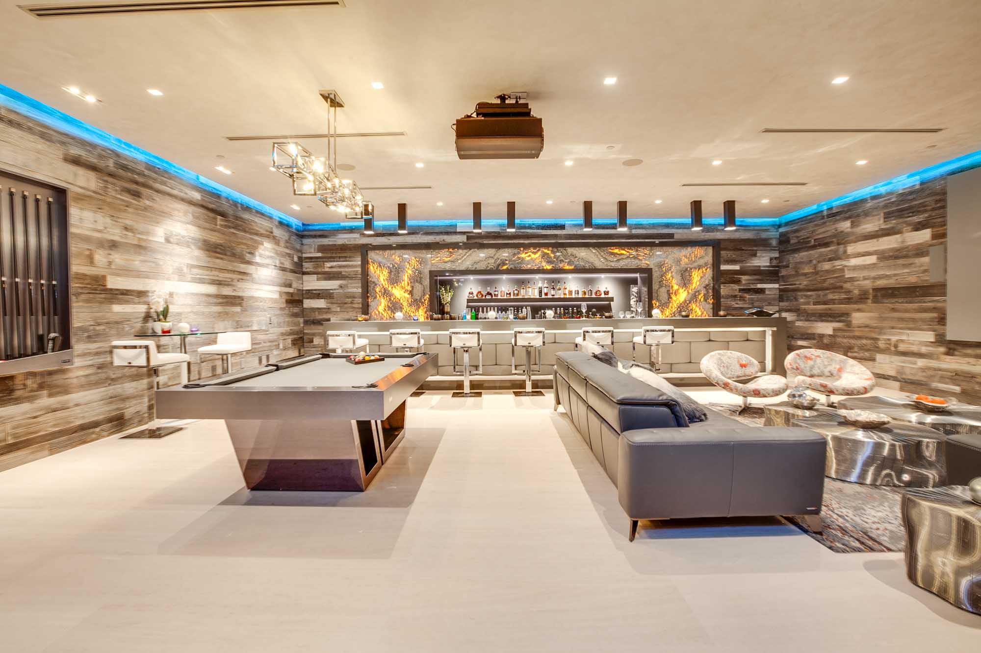 Luxury Entertainment Lounge with Custom Bar, Home Theater, and Game Room Design