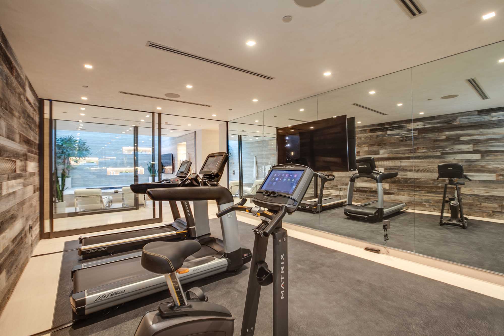 Private Luxury Home Gym with Floor to Ceiling Mirrors and High End Fitness Equipment