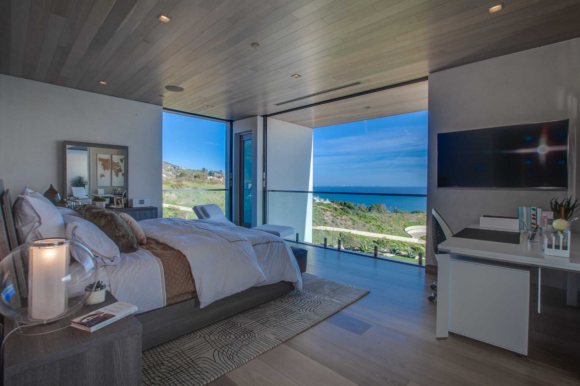 Luxury Ocean View Bedroom with Floor to Ceiling Glass and Private Balcony Access