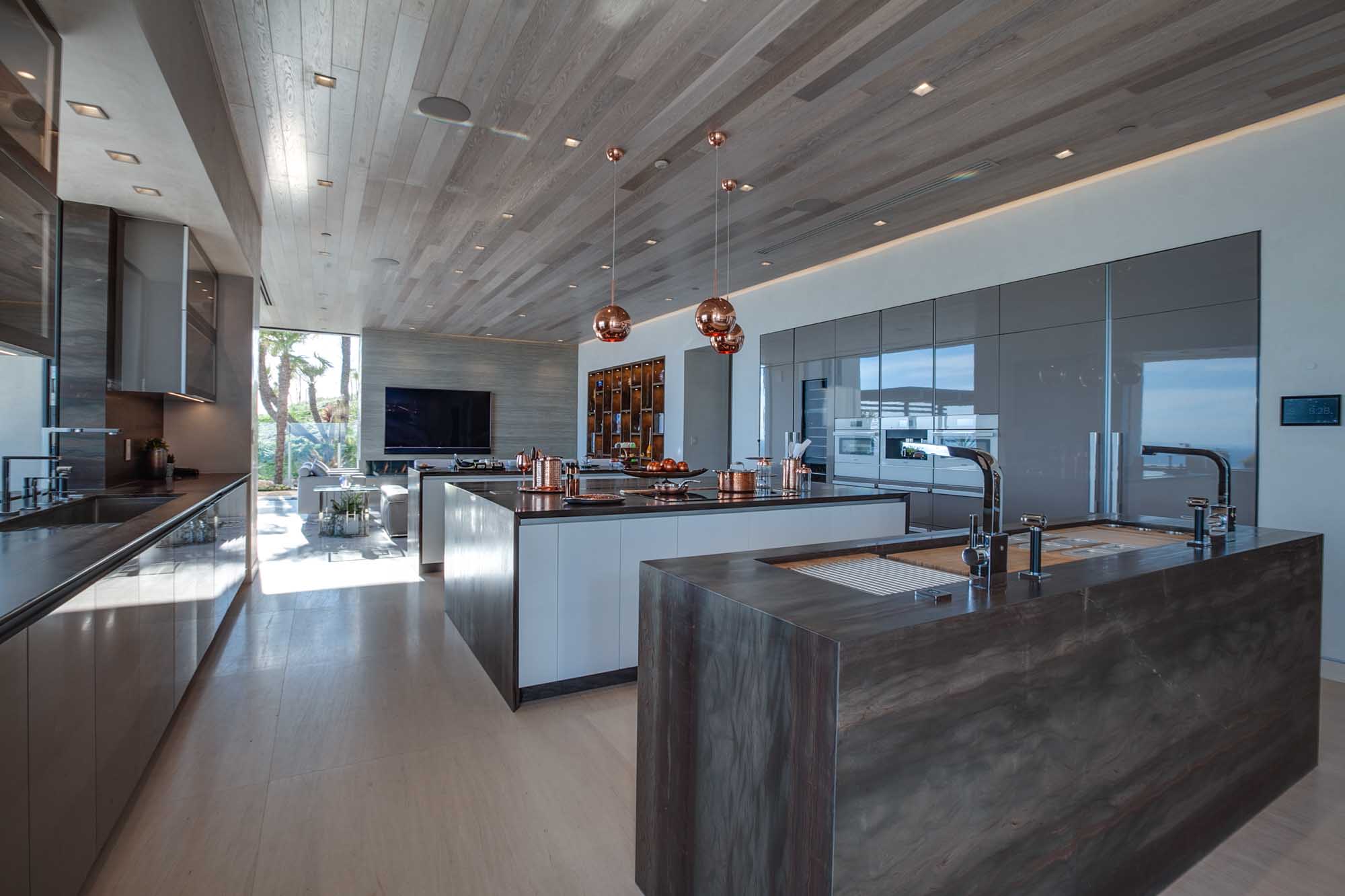 Modern Chef’s Kitchen with Dual Islands, Custom Cabinetry, and Seamless Indoor Outdoor Flow.
