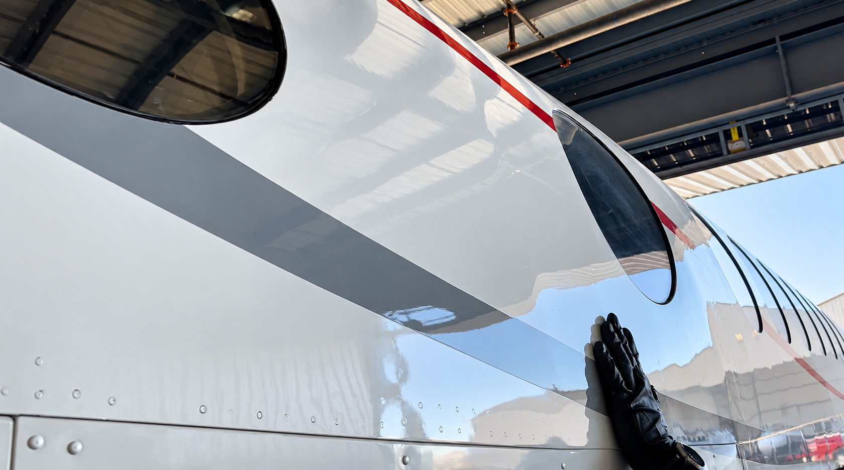 Detailer preparing polished metal surfaces before coating