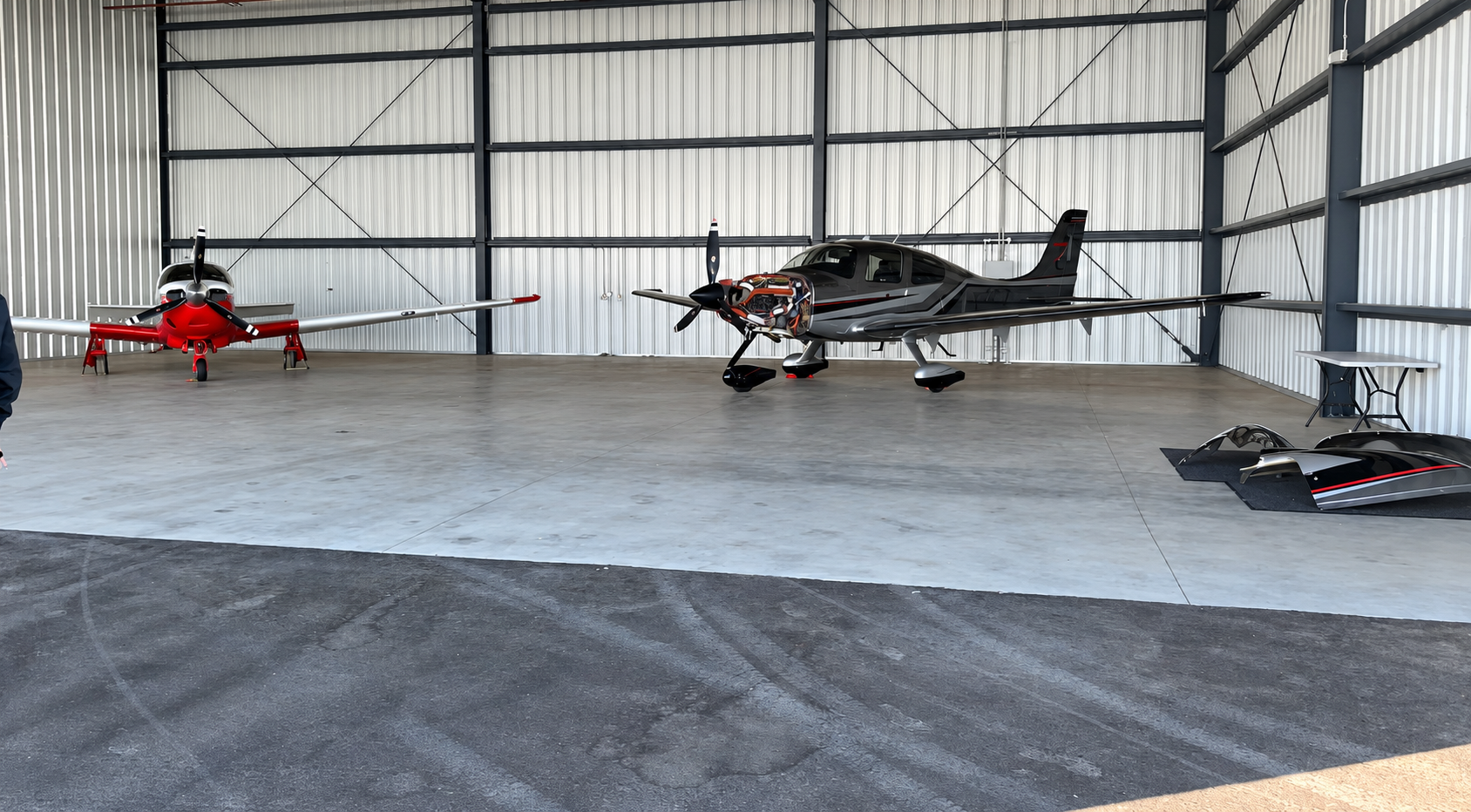 Private jet parked inside a dark hangar awaiting detailing