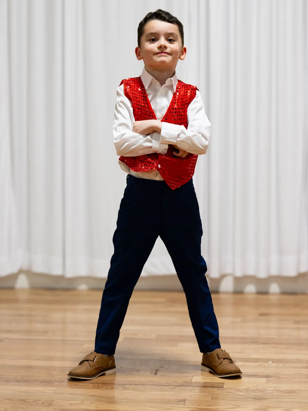 Young ballroom student in a red sequin vest at Ladu Dance Studio in Sandy, Utah