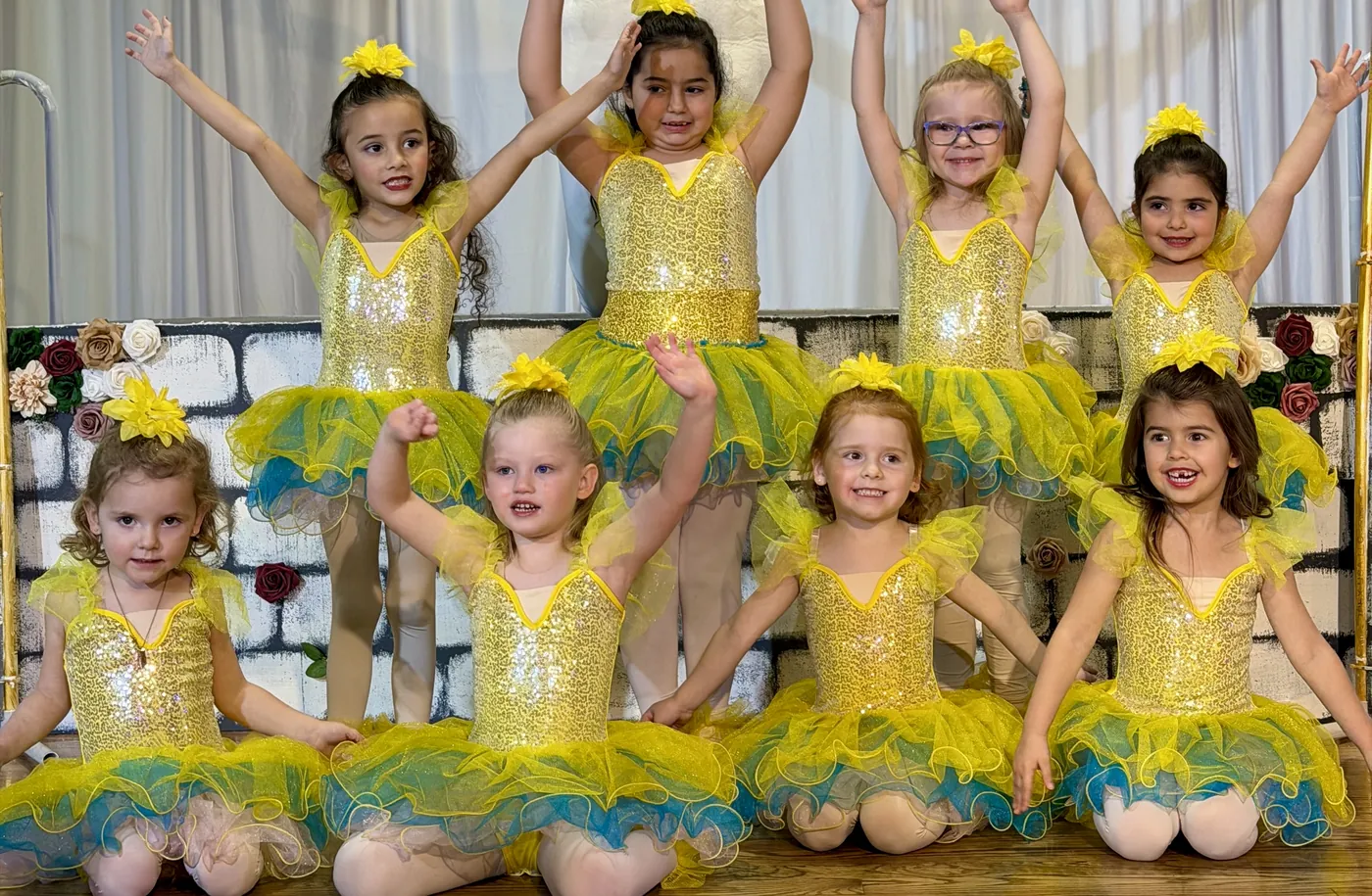 Young dancers ages 4 to 6 in yellow tutus at a Ladu showcase