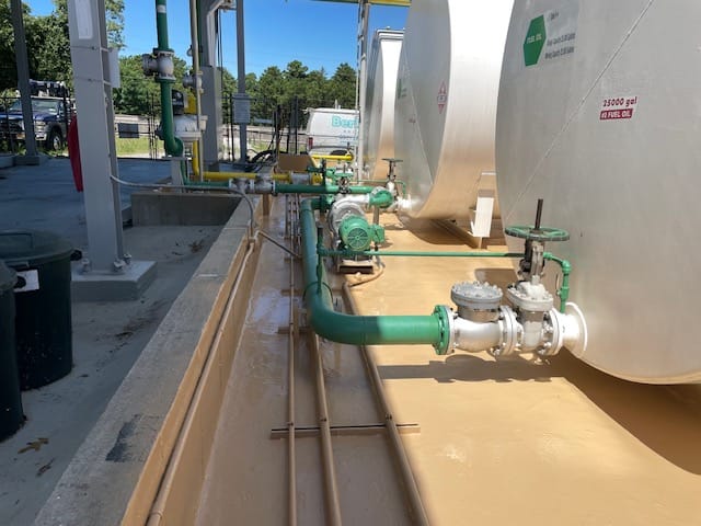 Coated concrete dike surrounding fuel oil storage tanks