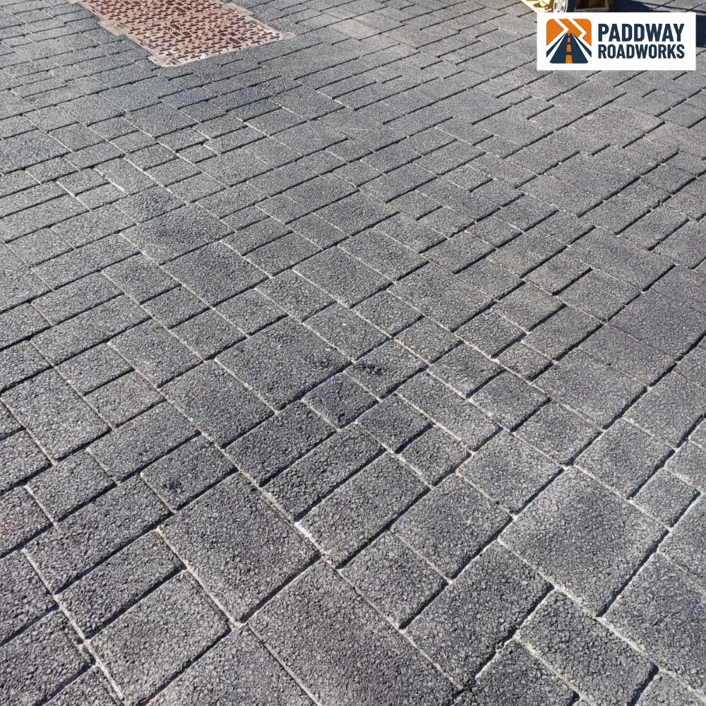 Block paving close-up showing red brick patch detail.