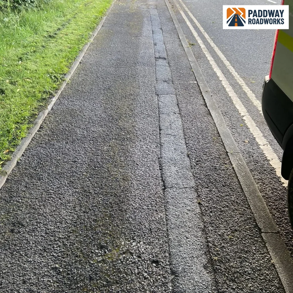 Slurry-sealed pavement finished — clean, smooth, residential street.