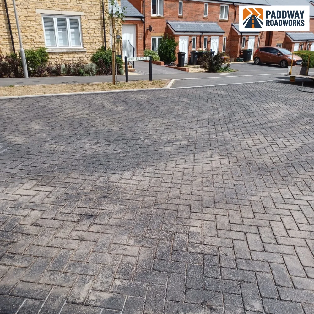 Large herringbone block-paved residential cul-de-sac.