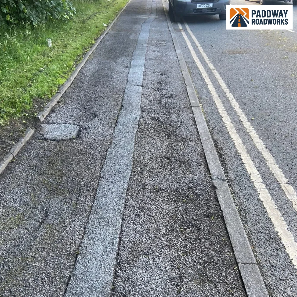 Slurry sealing in progress — same pavement mid-process with parked car visible.