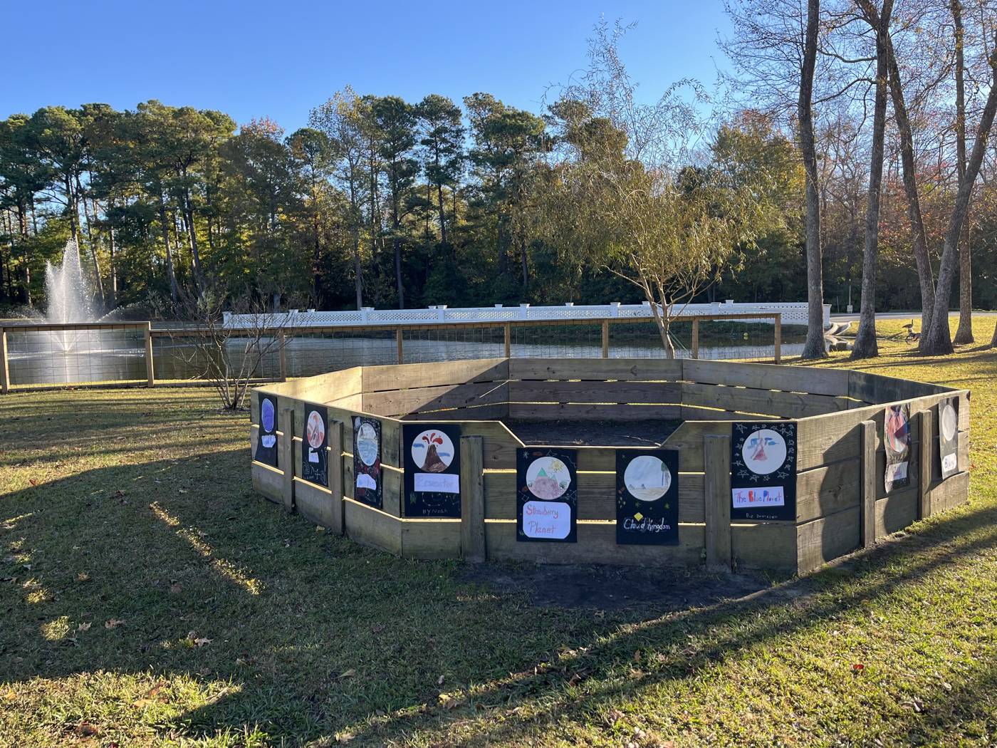 Outdoor learning space on the Topsail Montessori campus beside a pond