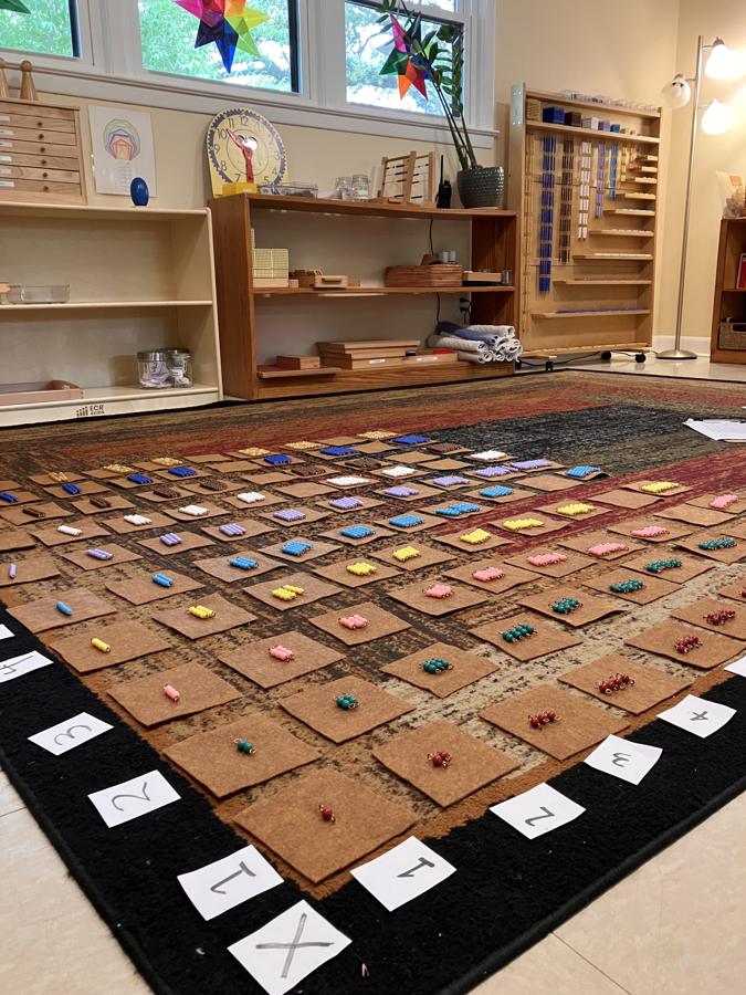 Montessori math materials laid out on a large mat