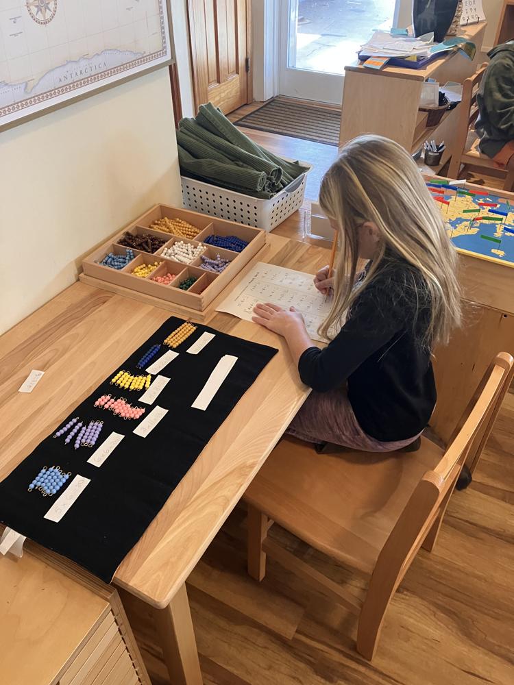 A student working at a classroom table