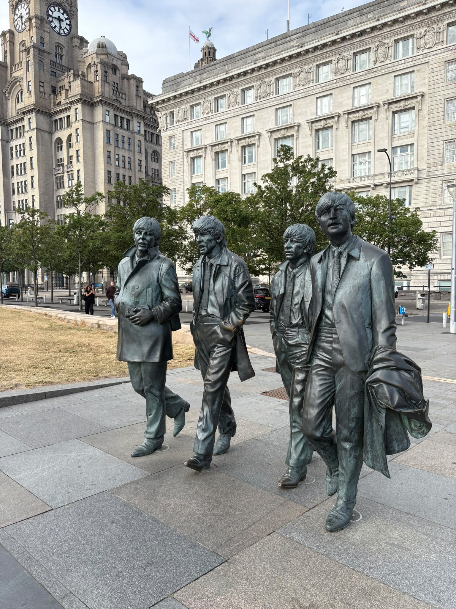 Bronze statues of four musicians in Liverpool, reflecting the city’s music history, creativity and lasting cultural spirit.