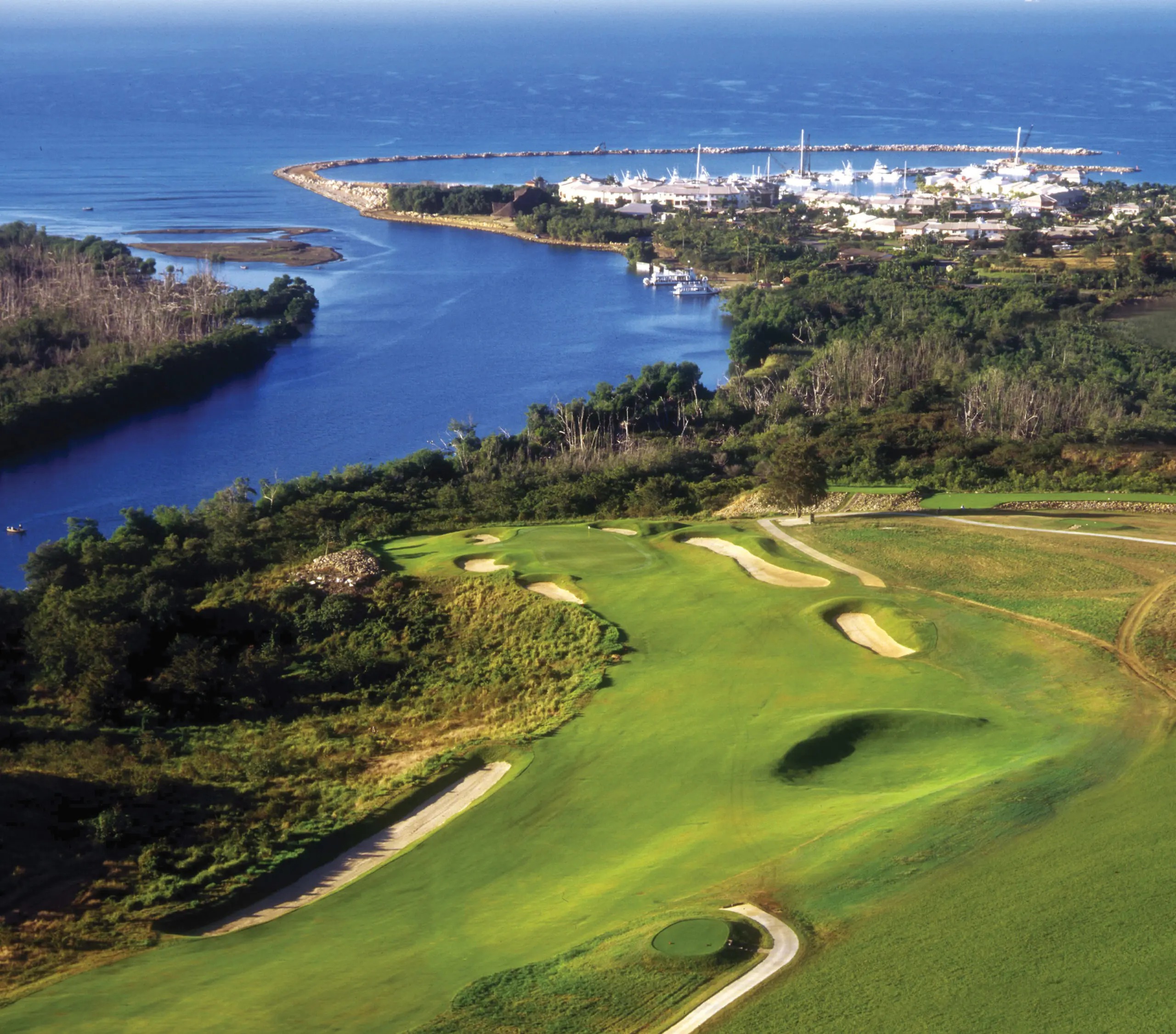 Aerial view of a Casa de Campo golf course, marina, and Caribbean coastline.