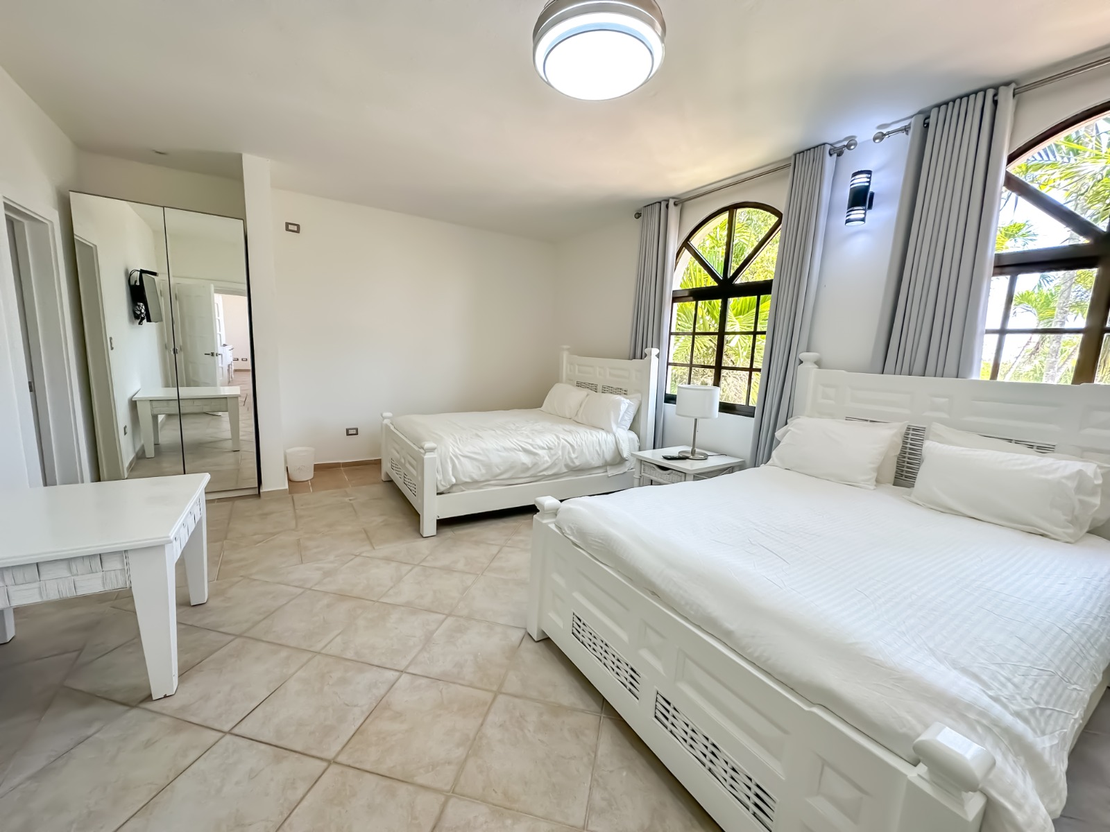 Bedroom with arched window at a private villa at Casa de Campo.