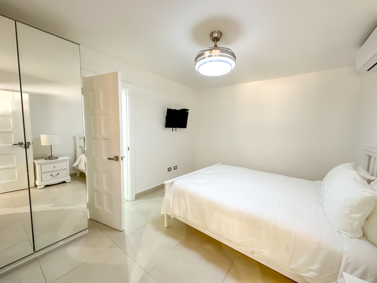 White bedroom of a private villa at Casa de Campo.