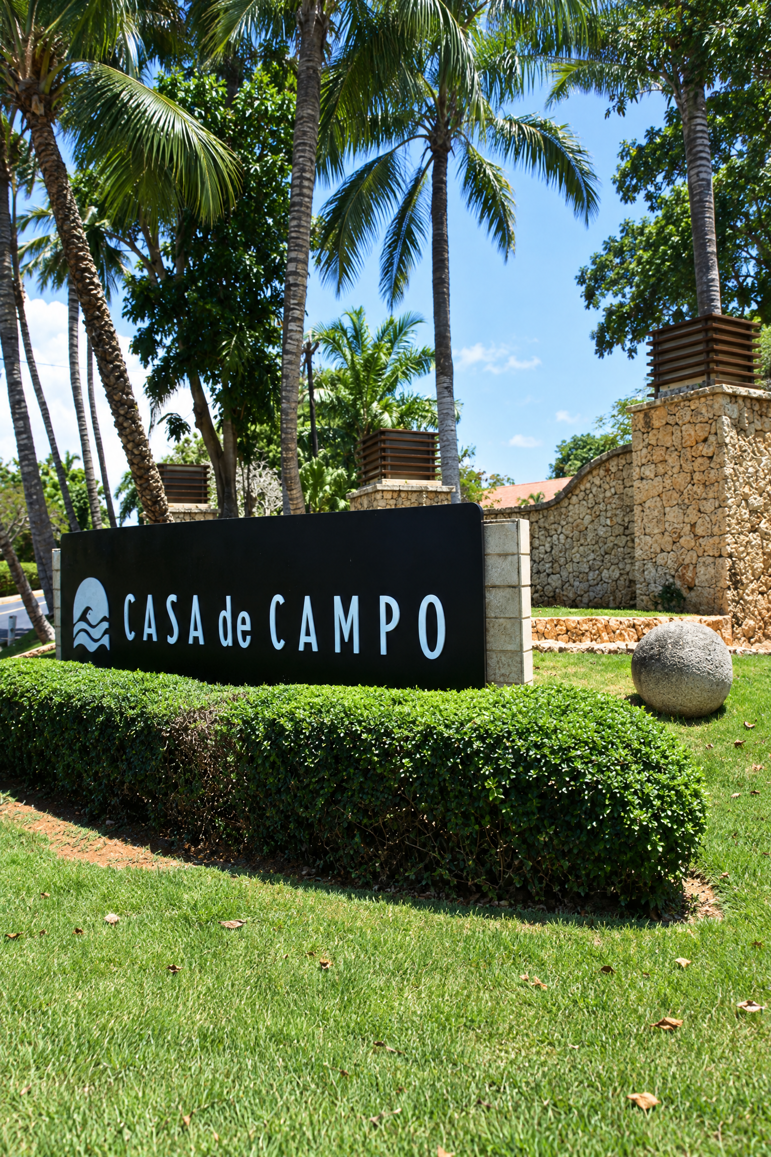 Casa de Campo entrance sign surrounded by tropical landscaping.