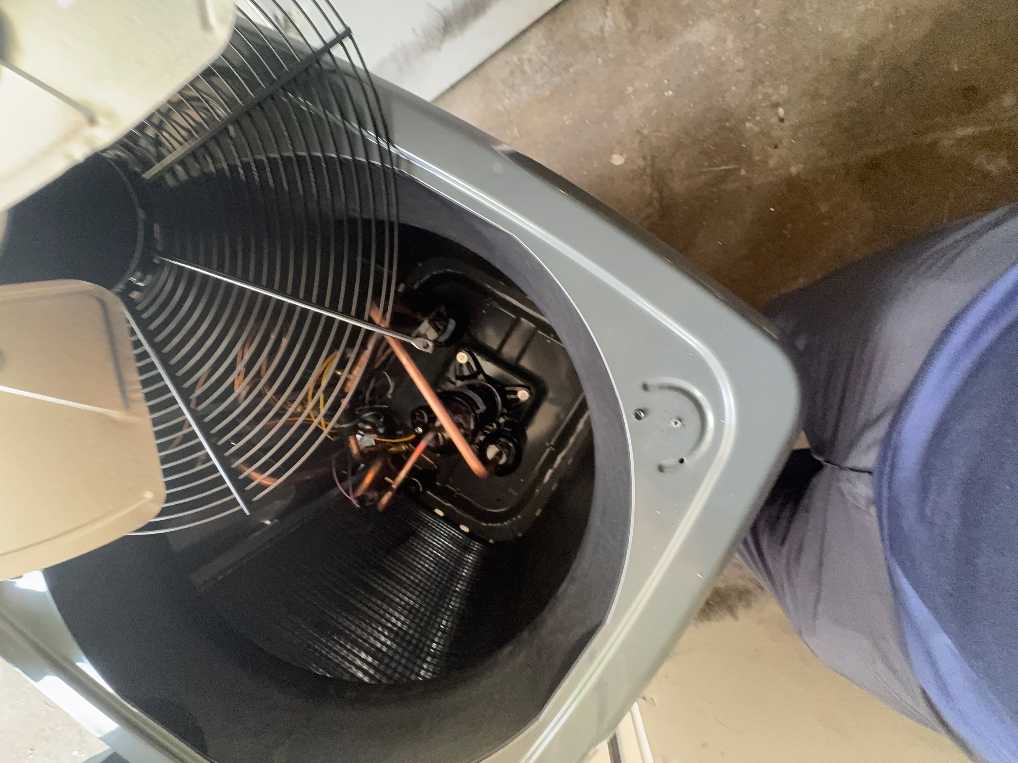 Outdoor HVAC unit undergoing preventive maintenance inspection