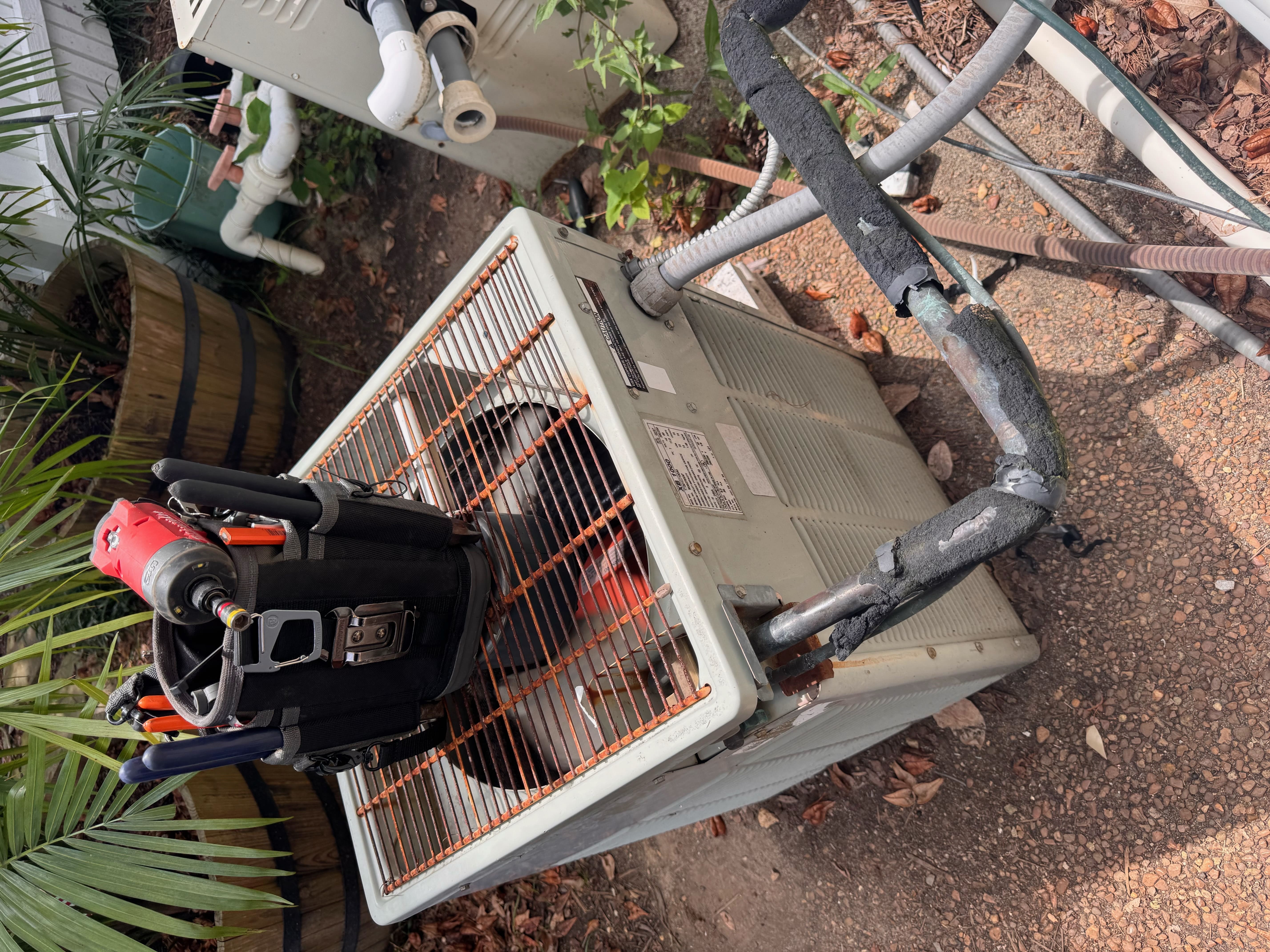 New residential outdoor air conditioning condenser unit installed next to home