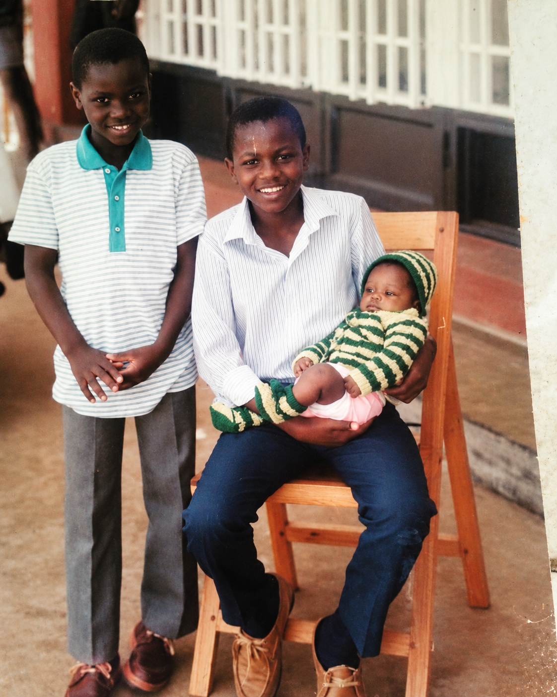 Aaron holding KuSos as a baby in an authentic family photograph