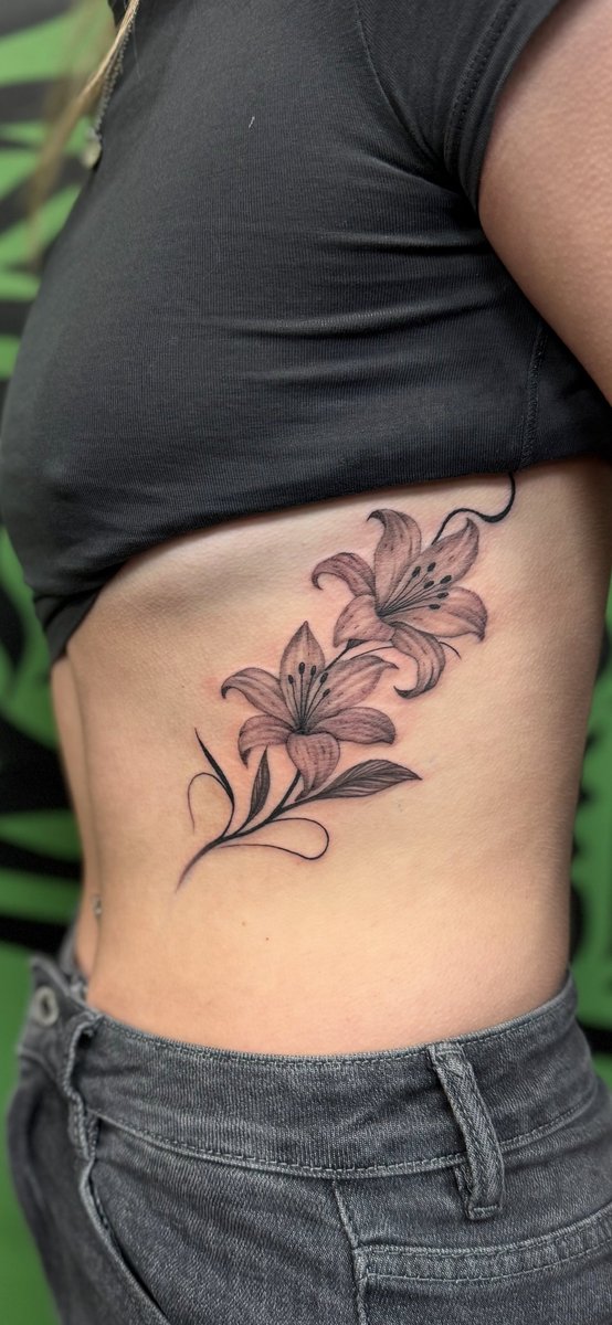 Fine line lilies tattoo by Danny Woods, Cheadle Hulme tattoo studio