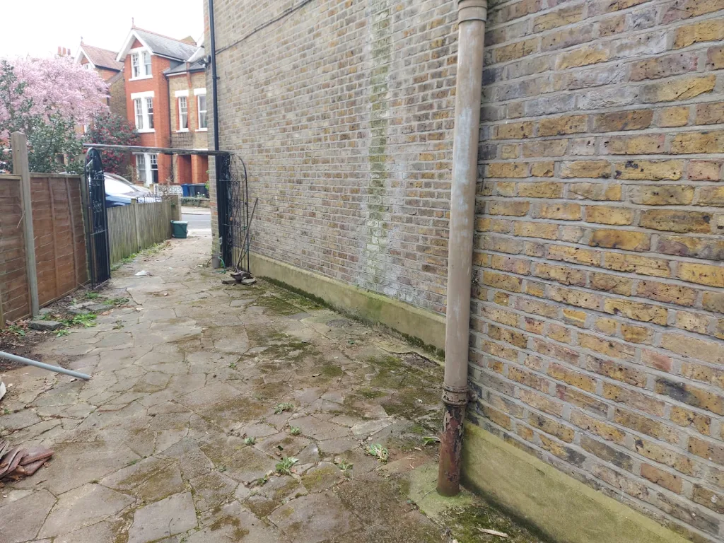 Clean wall and clear outdoor area after fence removal and waste clearance by Recycle DNC Ltd