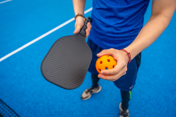 Backyard pickleball court with custom blue playing surface