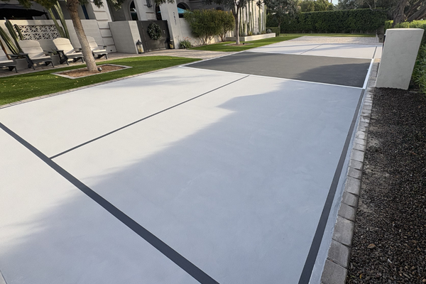Backyard pickleball court with custom grey playing surface