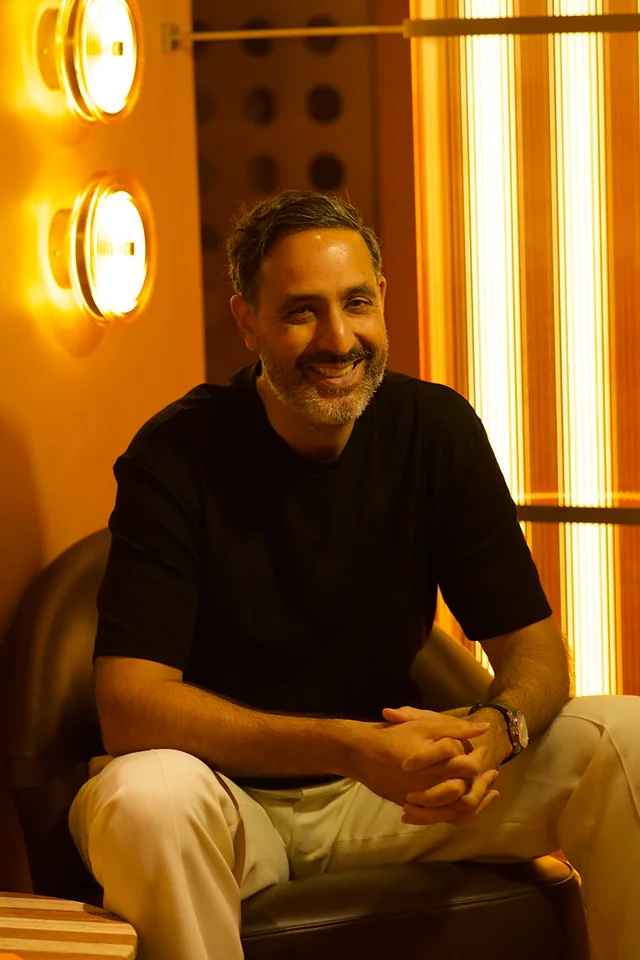 A guest seated in a warmly lit lounge