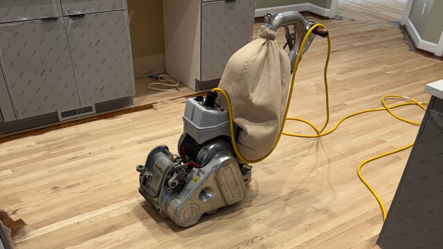 Dustless hardwood floor sanding and refinishing in progress on a Raleigh NC floor