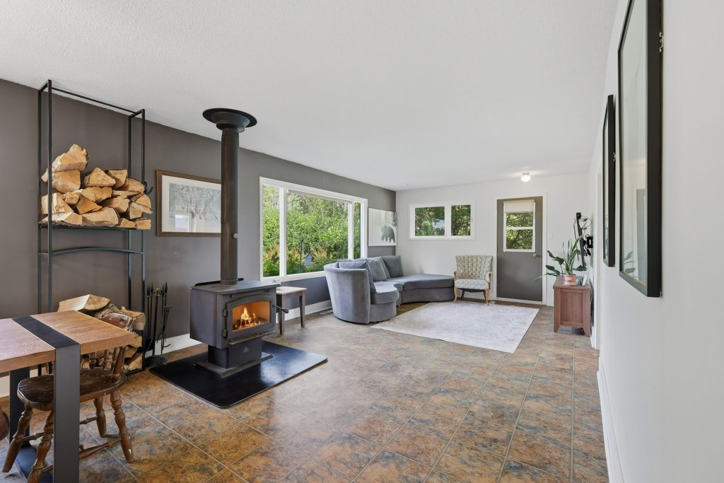 Dining and living area with wood-burning stove