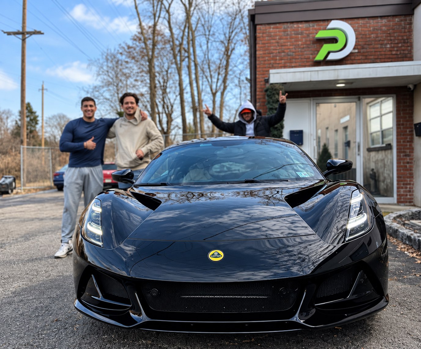 The Premier Detailing NJ team with a Lotus Emira outside the Scotch Plains shop