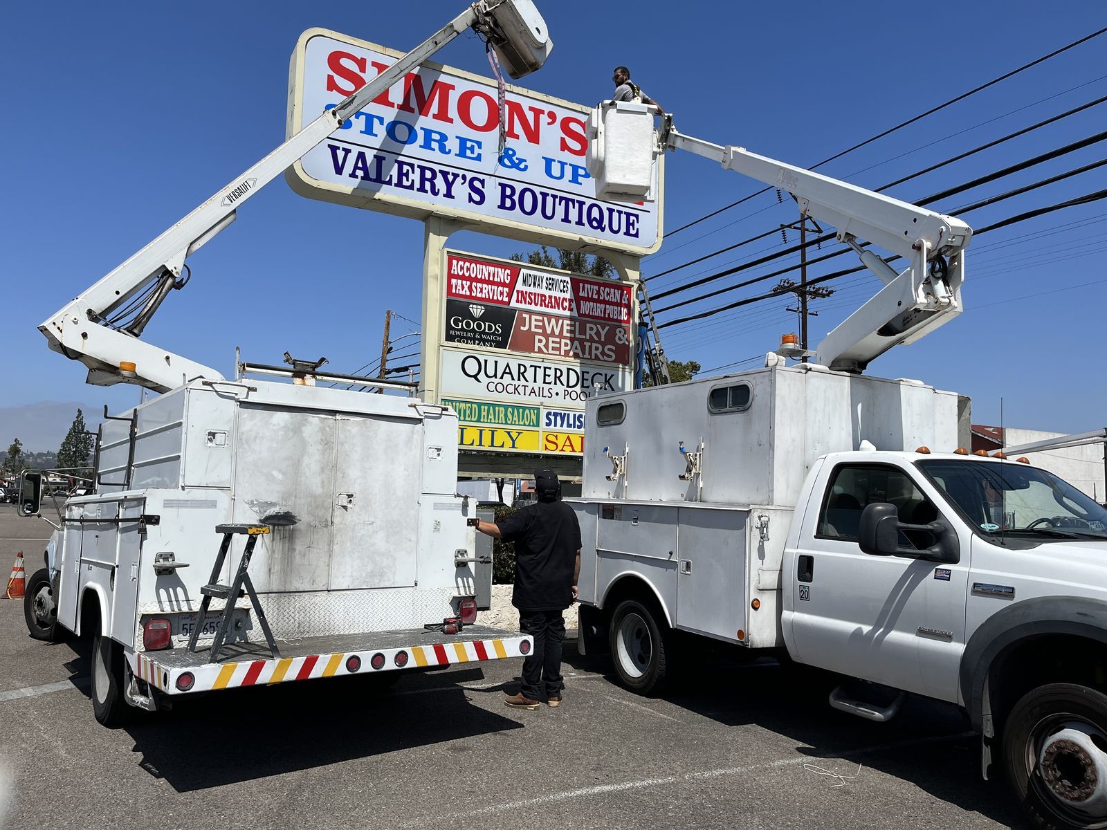 Great Signs Center bucket truck on a storefront sign installation