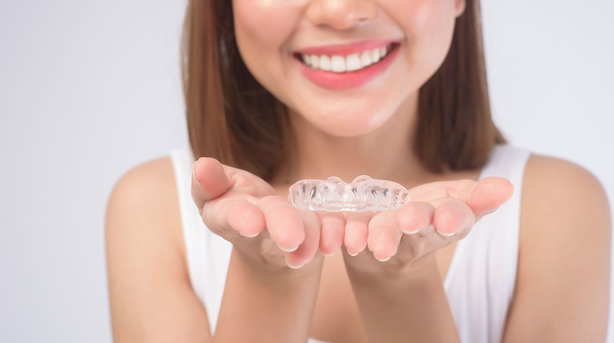 Patient holding an invisalign aligner