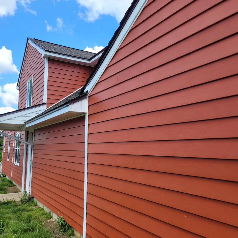 Close-up view of a house with newly installed vinyl siding, highlighting its smooth finish and vibrant color