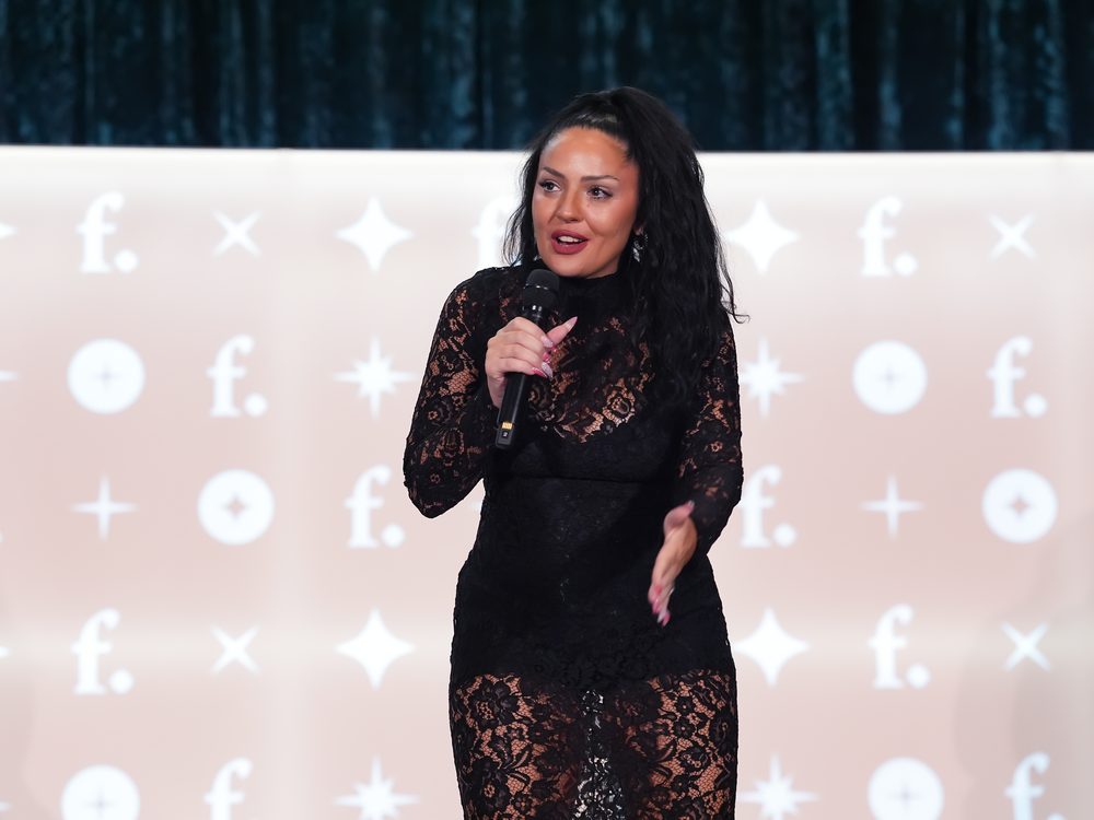 Marina Simone presenting with a microphone